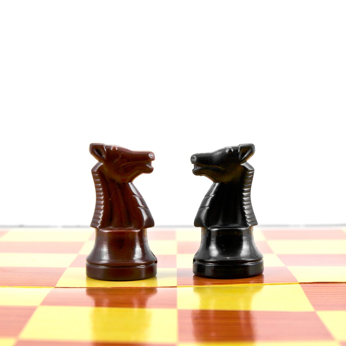 fighting between white and black knights on chess board